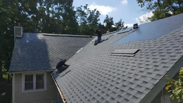 Professional asphalt shingle roofing installation on a residential home in Everett MA.