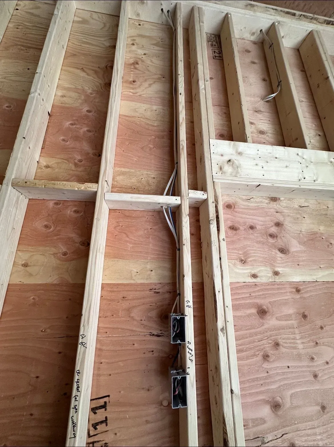 A wooden wall with a wire coming out of it.