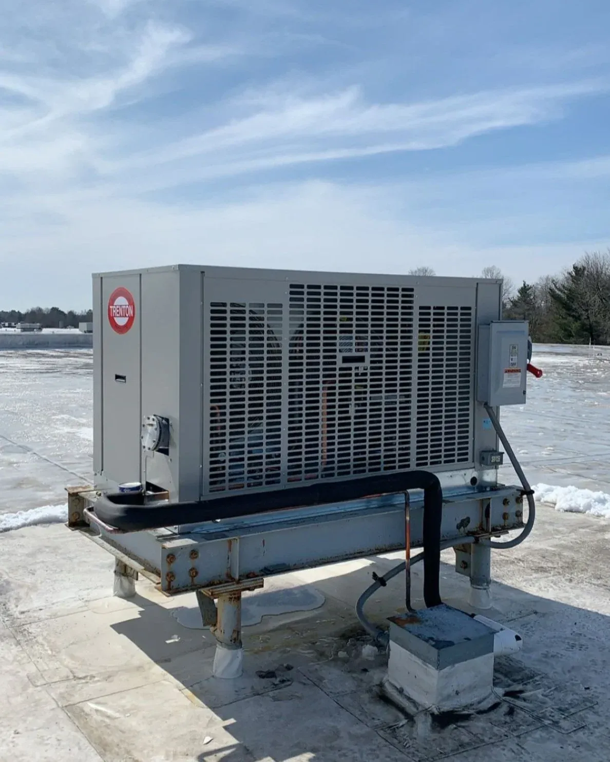 Rooftop industrial HVAC unit in a snowy setting