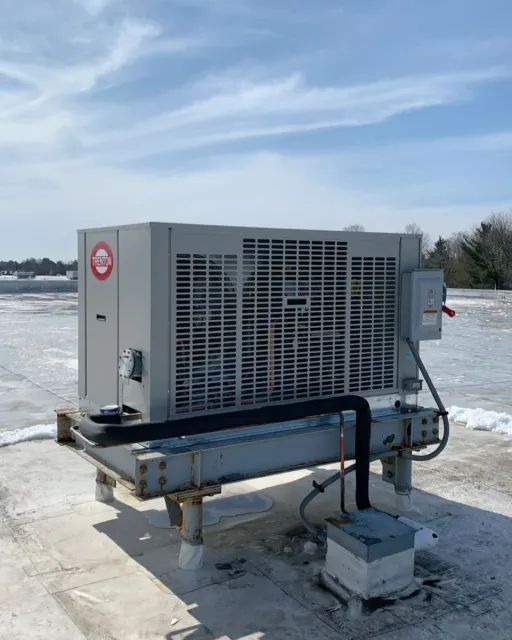 Rooftop industrial HVAC unit in a snowy setting
