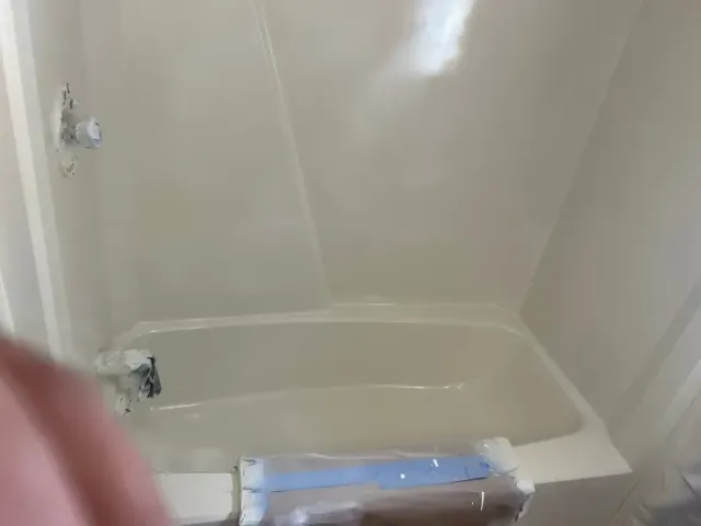 Blue bathtub and surround after reglazing with a clean white finish