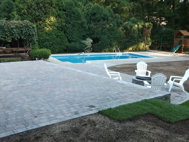 Hardscaping project in Massachusetts. Patio project by the pool. Outdoor firepit installation in Burlington.