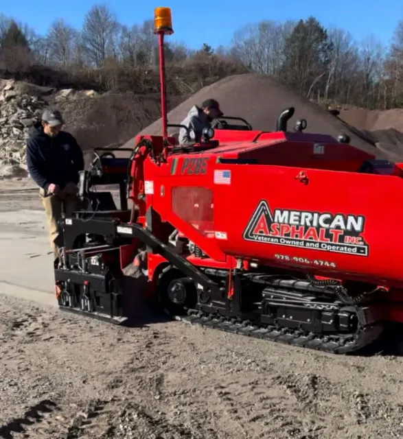 A red machine that says ' american asphalt ' on it