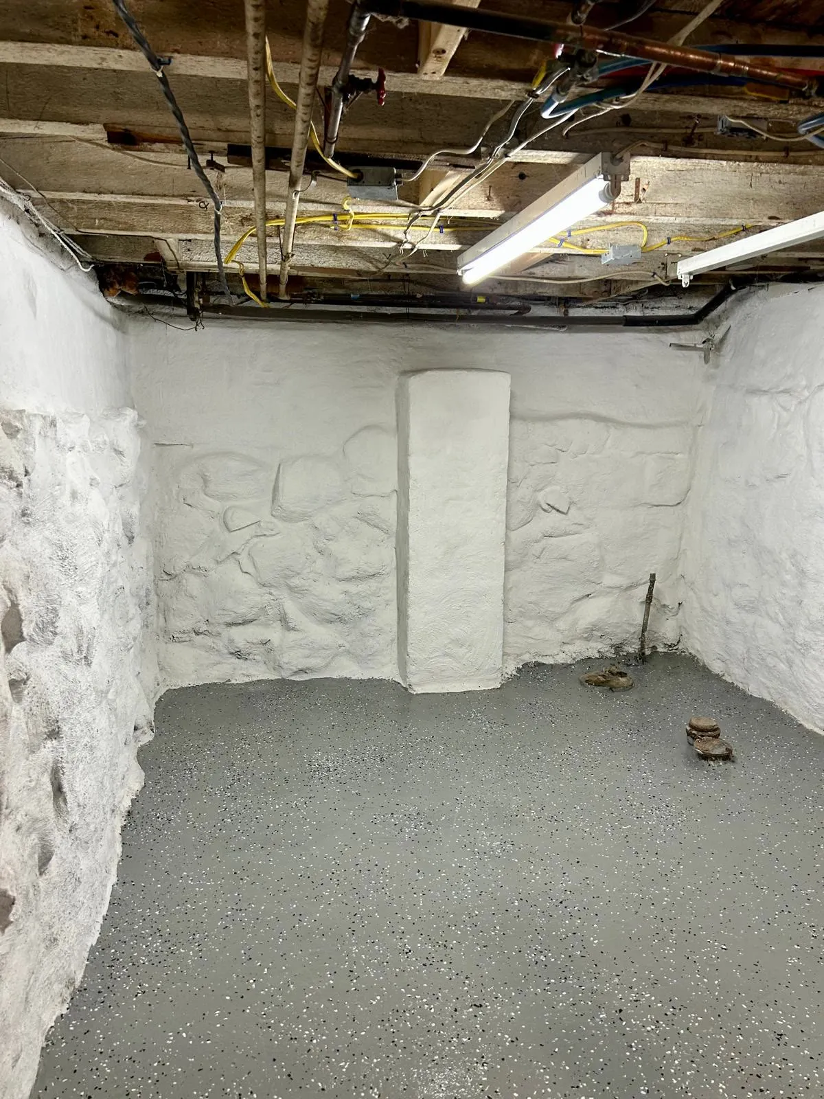 Improved basement with repaired and protected masonry walls