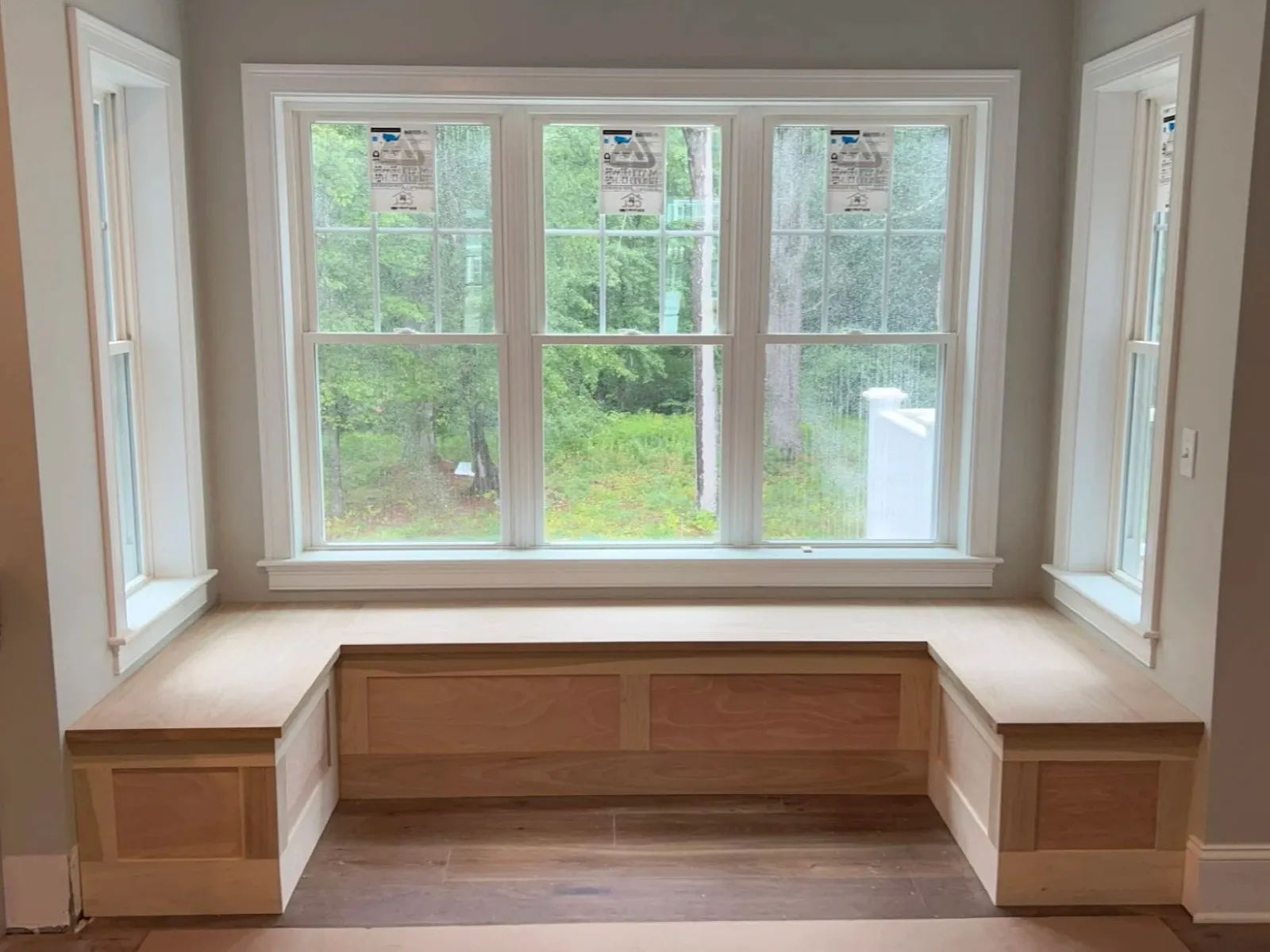 Custom window seat and built-in bench installed by Reimagined Joinery