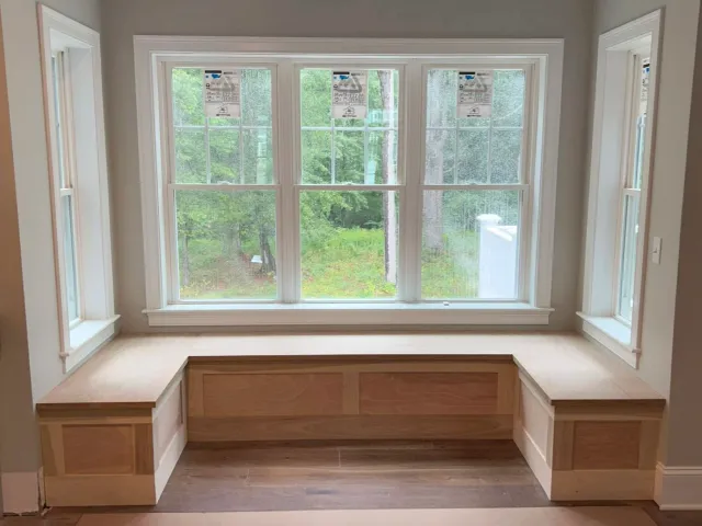 Custom window seat and built-in bench installed by Reimagined Joinery