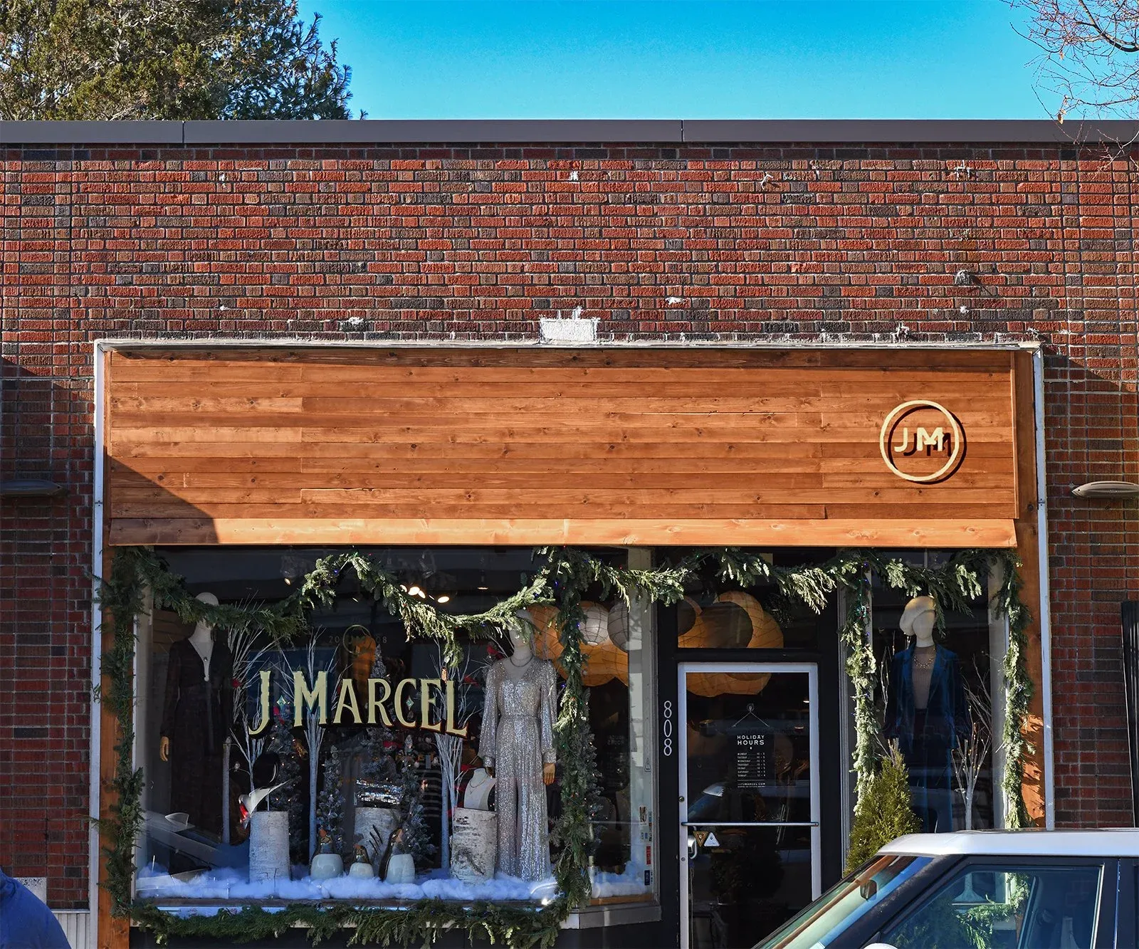 Exterior of J Marcel store with brick and custom wood facade, work done by LSC Carpentry LLC.