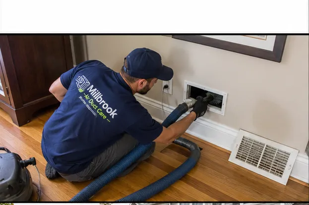 Millbrook Air Duct Care technician cleaning an air duct vent in a Worcester, MA home
