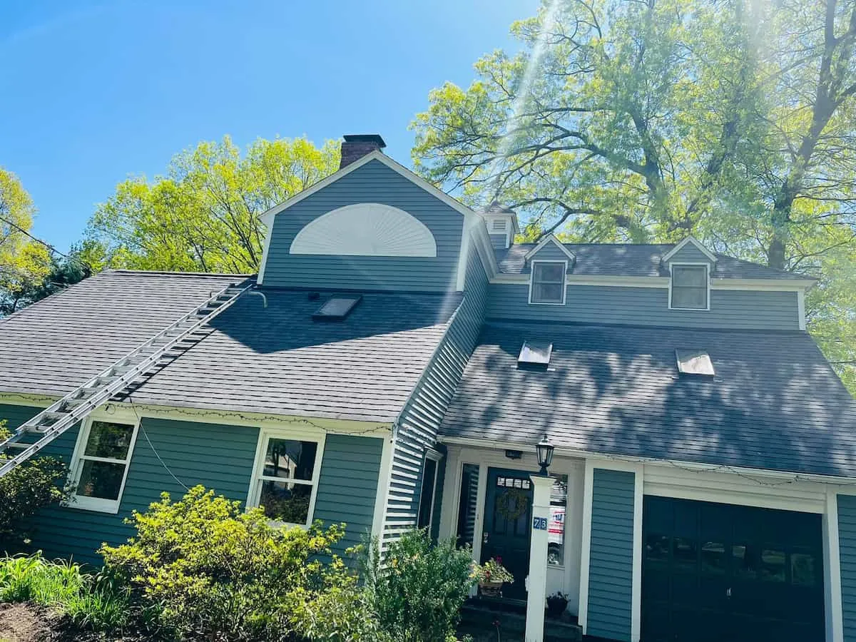 Crew ladder set at a shingled residential roof job