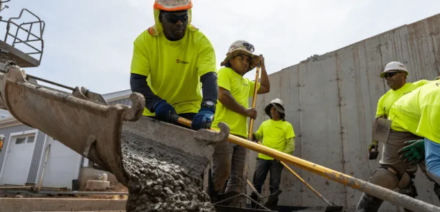 Sweeney, employees, concrete, pushing concrete, spreading, concrete-services-min