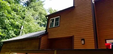 Back of house with brown siding