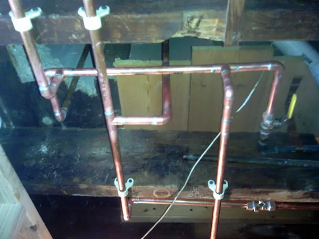 New copper supply lines run under a basement ceiling