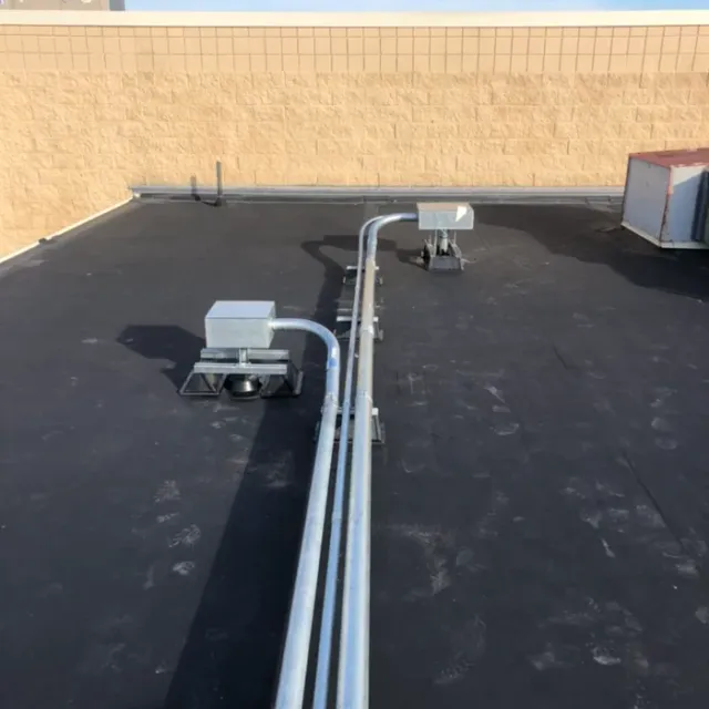 Rooftop conduit runs on a commercial building