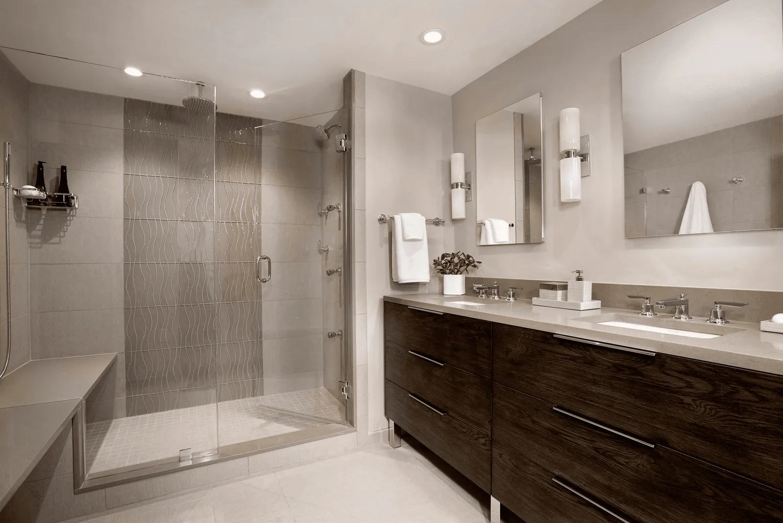 Tiled walk-in shower and vanity wall