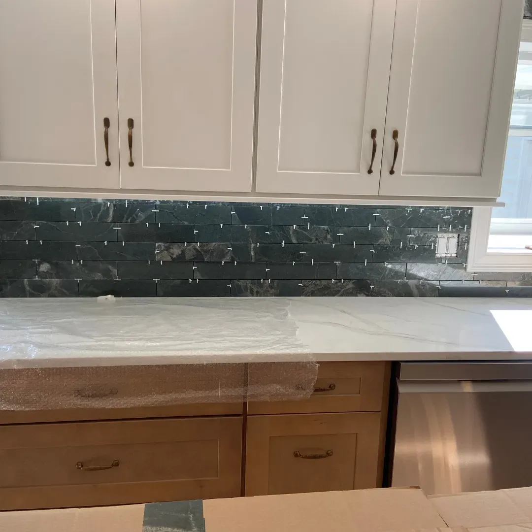 Kitchen install with white shaker cabinets, quartz counter and emerald green stone mosaic b by SF Construction in Sudbury, MA