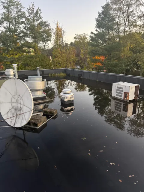 Flat commercial roof with ponding water before coating