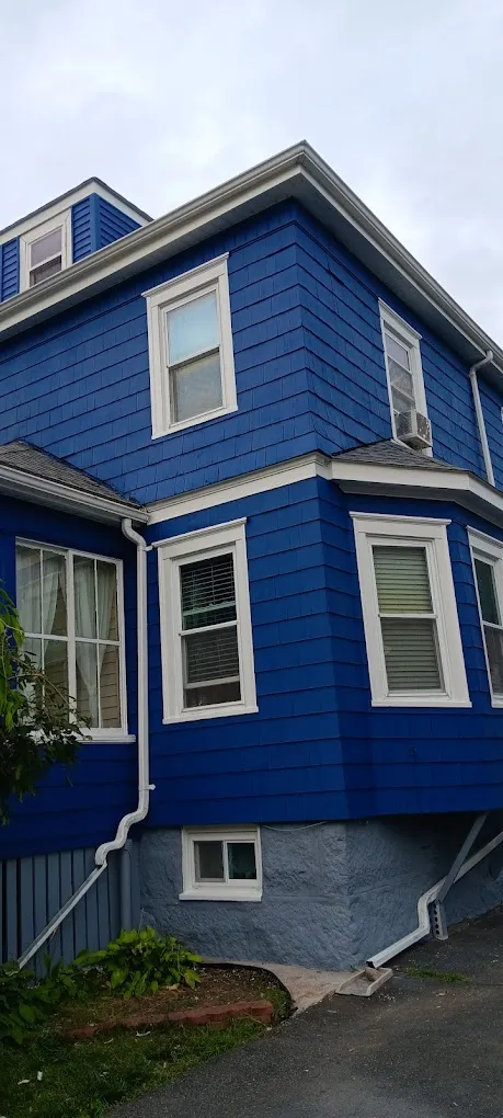 Blue house with white trim exterior painting project in Massachusetts - professional house painters