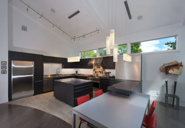 A kitchen with stainless steel appliances and a large island
