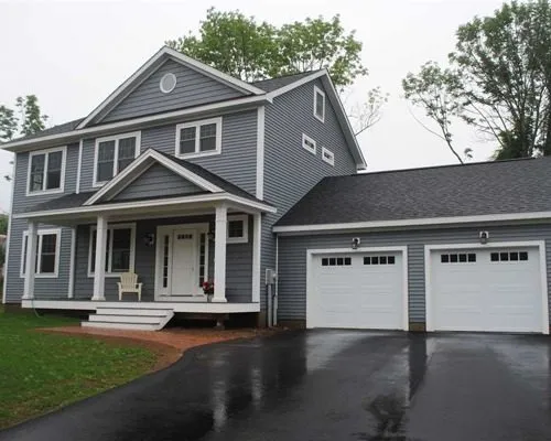2-Story manufactured home with attached garage and shed roof porch with dormer