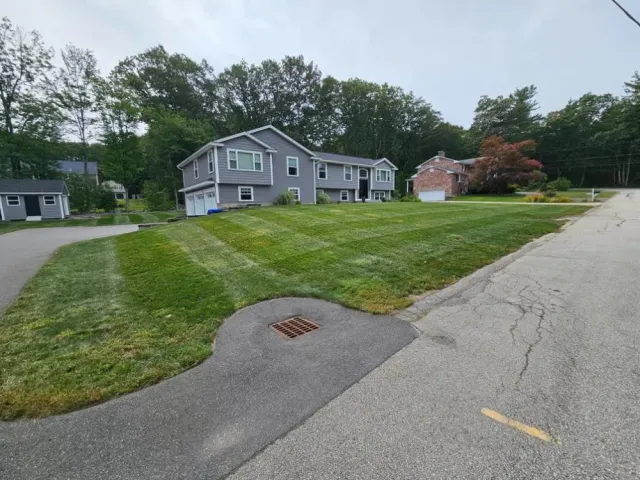 Freshly mowed hillside lawn in a Hudson, NH neighborhood