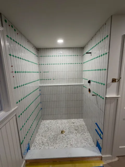 White subway tile shower installation by Tile of America in West Yarmouth, Massachusetts