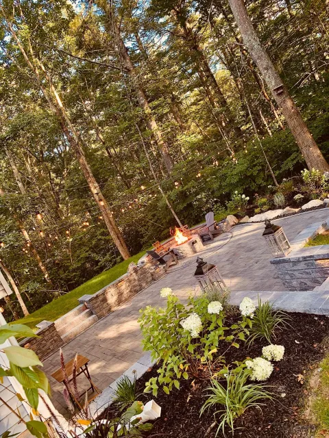 There is a fire pit in the middle of the woods.