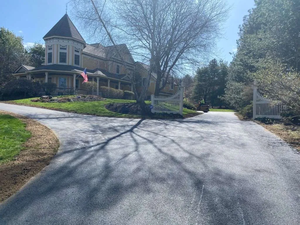 Residential driveway with a large house and gate