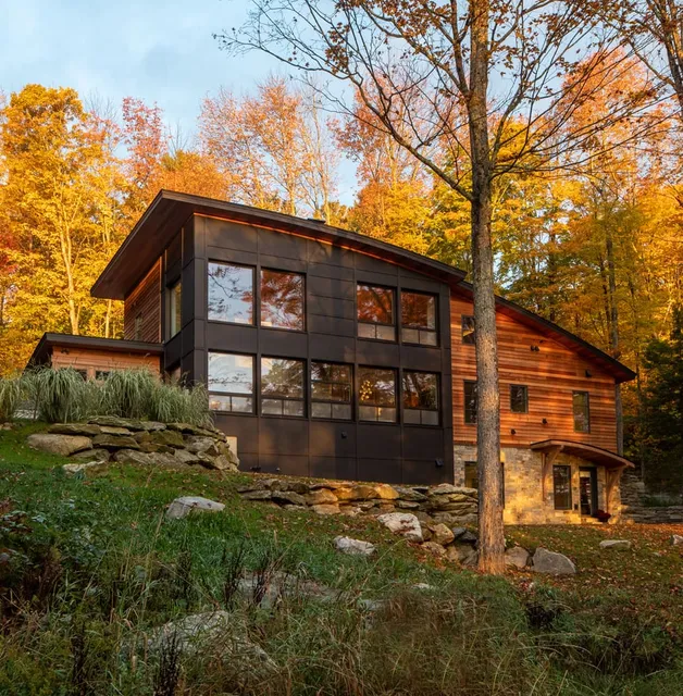 Curved roof house on a hill in autumn
