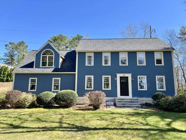 Two-story blue gable-front colonial in Buzzards Bay with new CertainTeed Landmark Pro Moire Black roof, Palladian-window dormer, and white trim