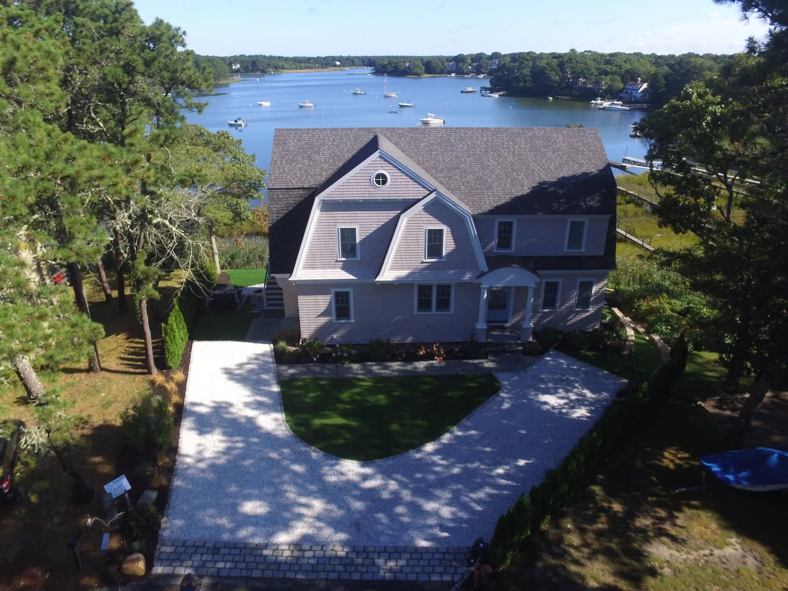 Arial view of a large home with a lake in the background