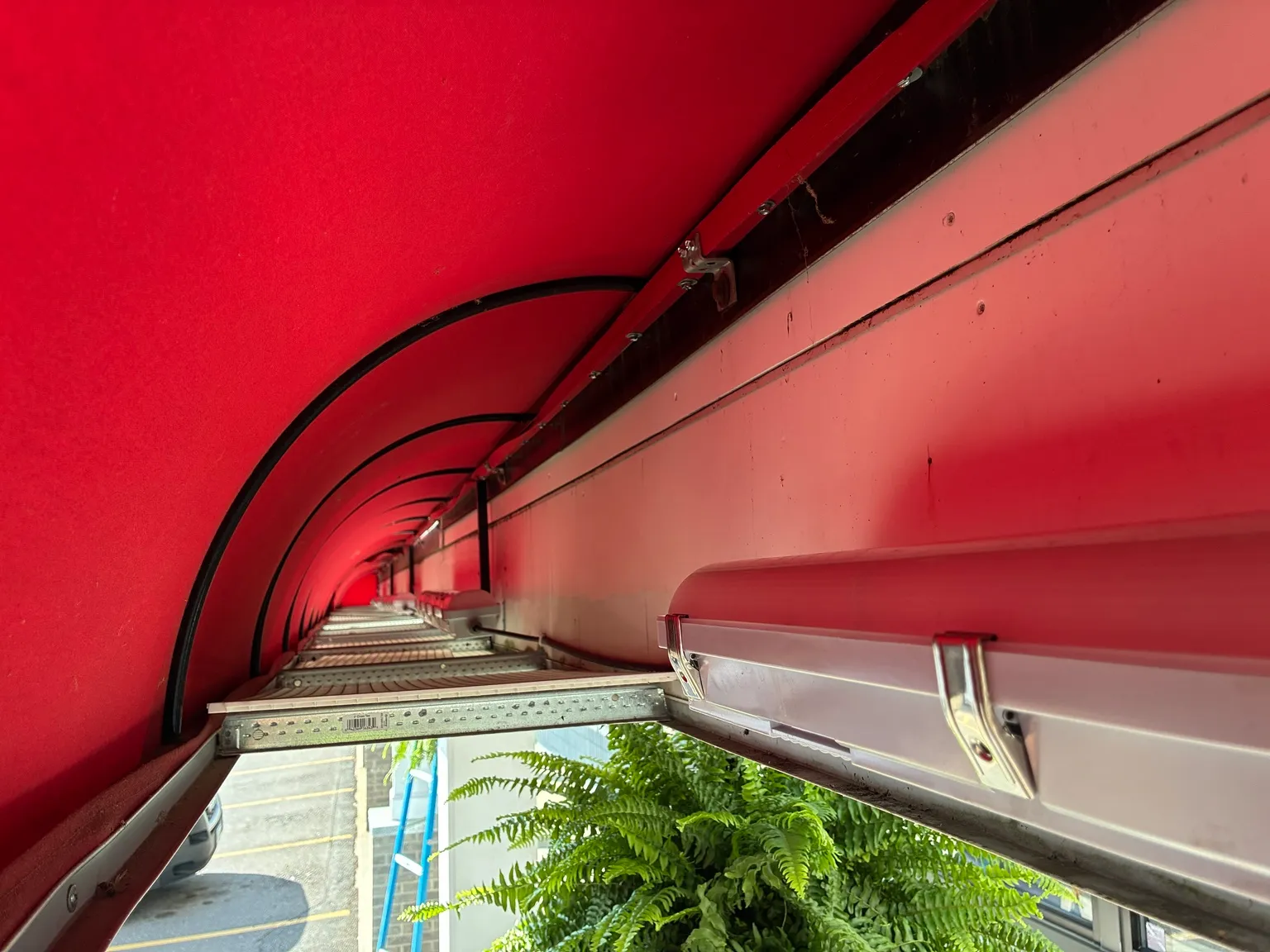 Weather-resistant linear LED fixture installed under commercial awning