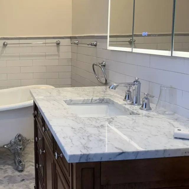 Marble vanity top meeting a dark wood cabinet