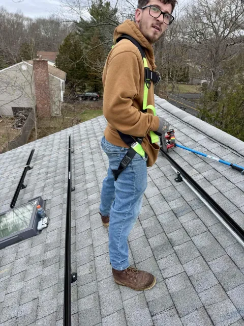 Rooftop Power installer servicing a solar system on the roof