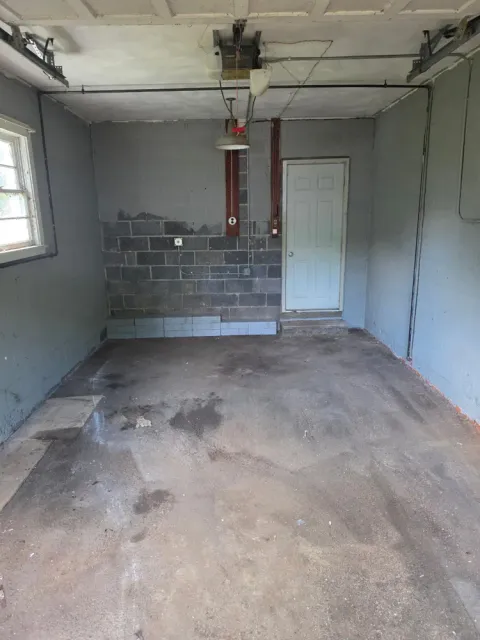 The same garage empty and swept after the cleanout