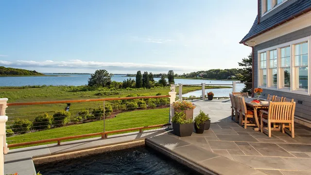 patio with jacuzzi and water view