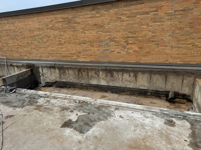 Long concrete wall section removed at commercial construction site