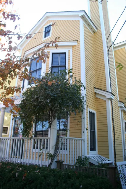 Exterior repaint, yellow clapboard with white trim
