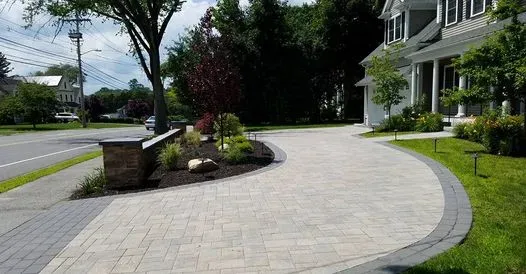 Paver driveway installation in Lexington, MA. Hardscaping paver driveway design, outdoor lighting, and retaining wall.