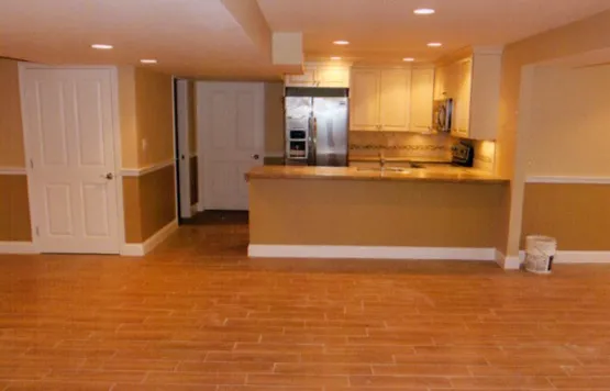 Finished basement with kitchenette and hardwood floor