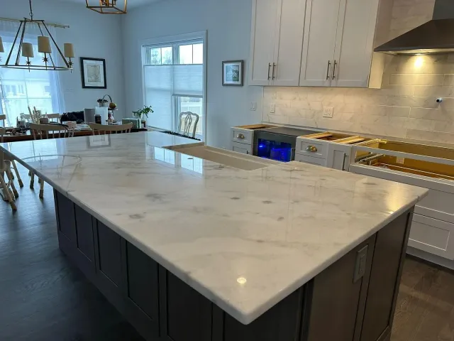 There is a large island in the middle of the kitchen.