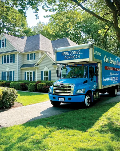 A moving truck parked in front of a house.