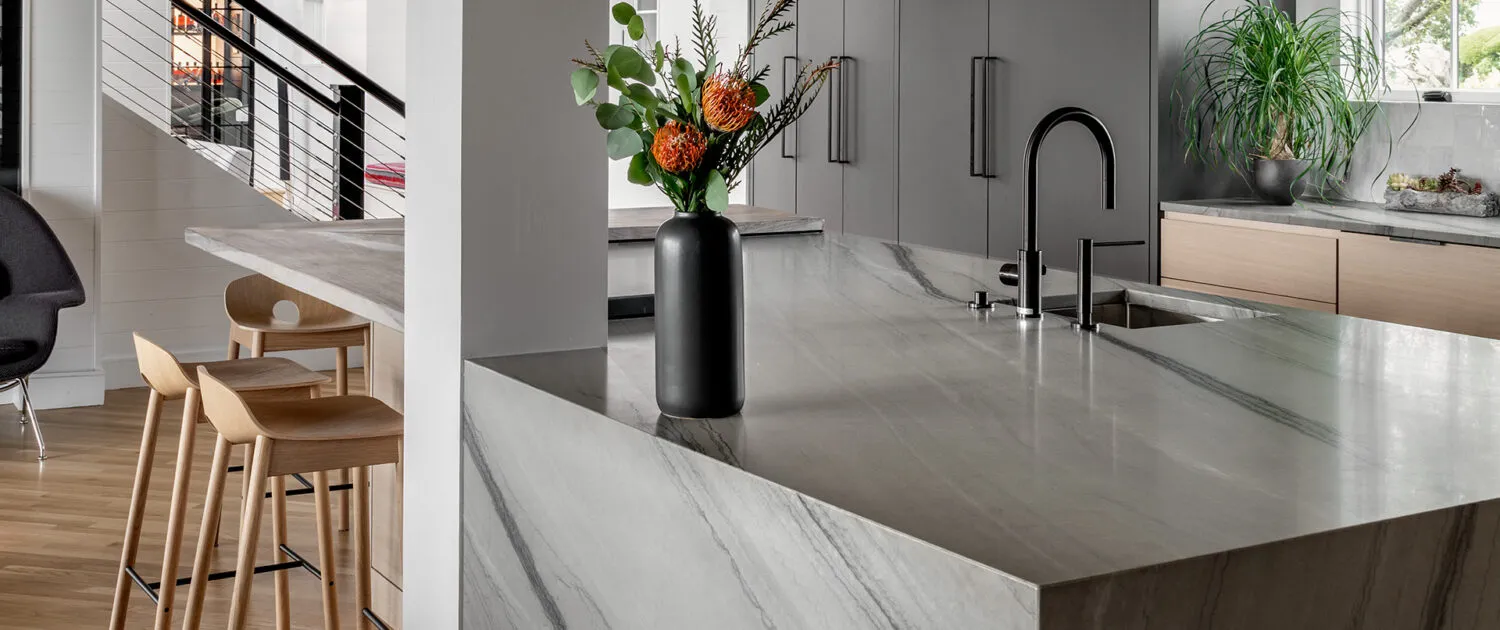 ARS Construction kitchen island with marble countertop and modern faucet