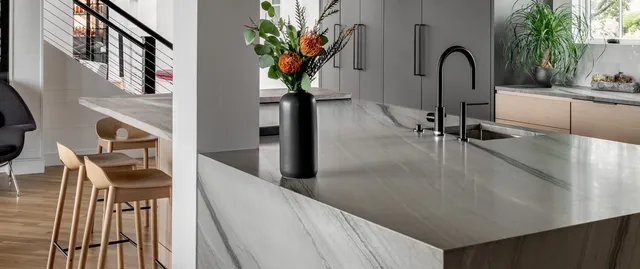 ARS Construction kitchen island with marble countertop and modern faucet