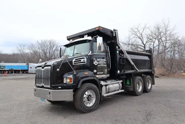 John H. Bensavage LLC black Western Star dump truck parked in lot