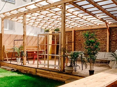 residential-deck-with-screen-pergola-and-outdoor-chairs-table-and-potted-plants-decorations-in-rochester-nh