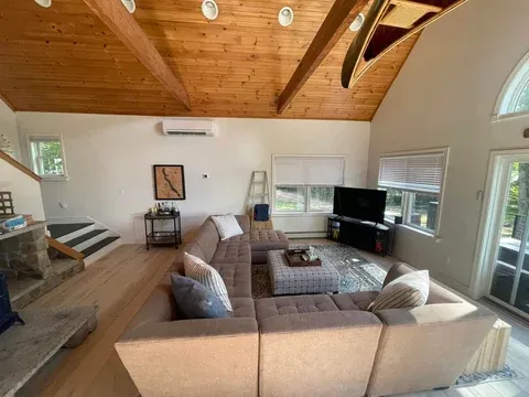 Pristine living room with exposed beam ceiling — vacation rental cleaning Windham ME