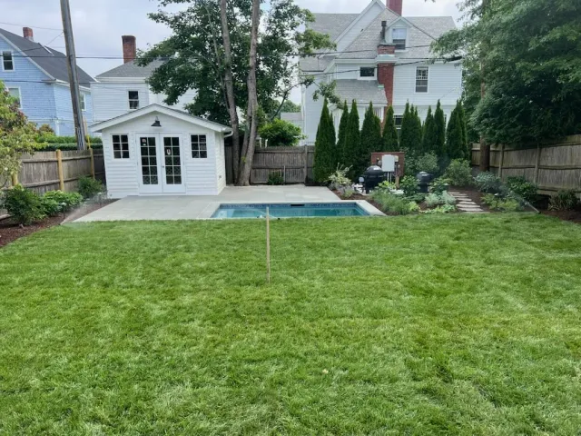 A backyard of a residential home with an installed irrigation system