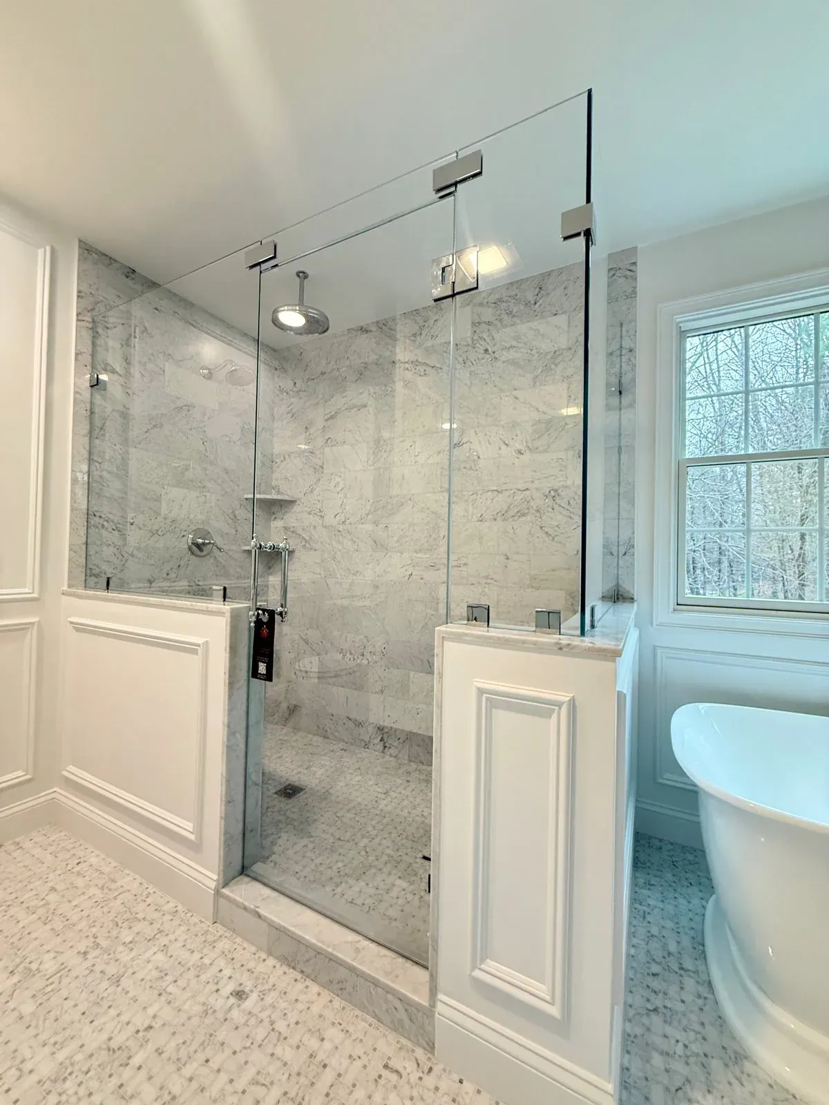 Classic frameless shower with chrome hardware