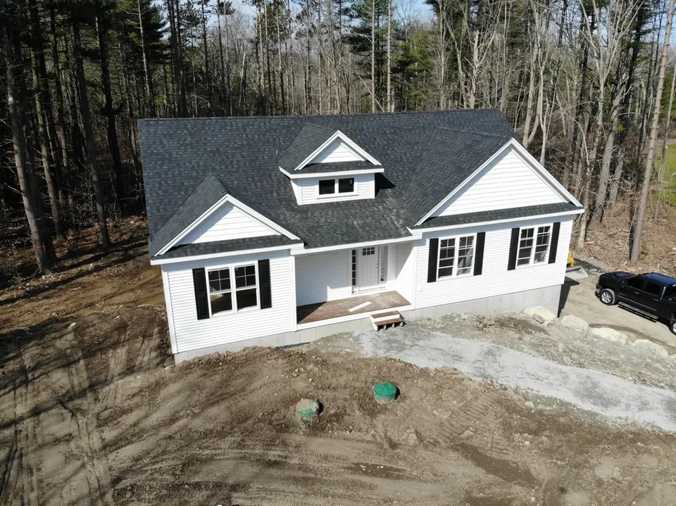 New white house with dark roof and black shutters