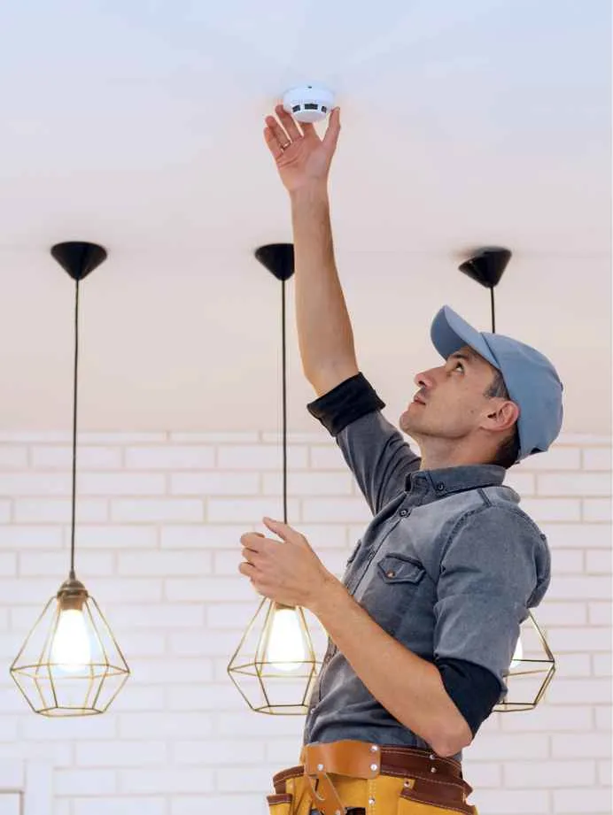 Man installing smoke detector